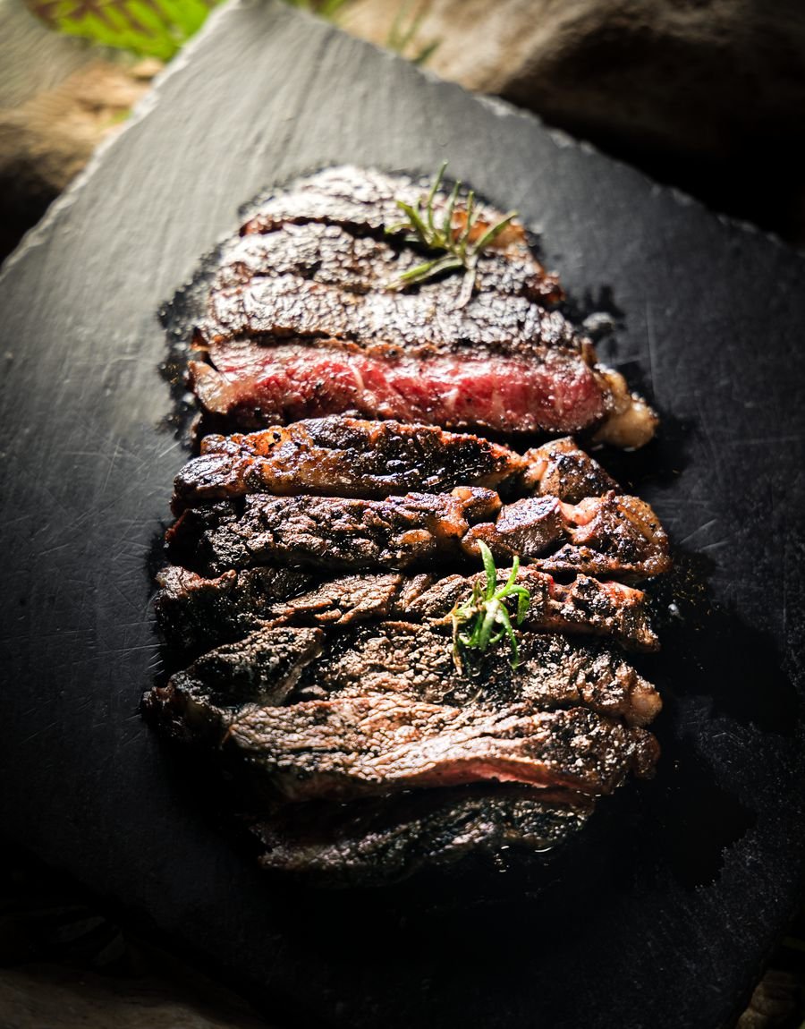 Sliced steak on a slate board