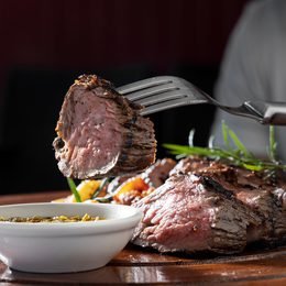 Steak slice lifted on a fork